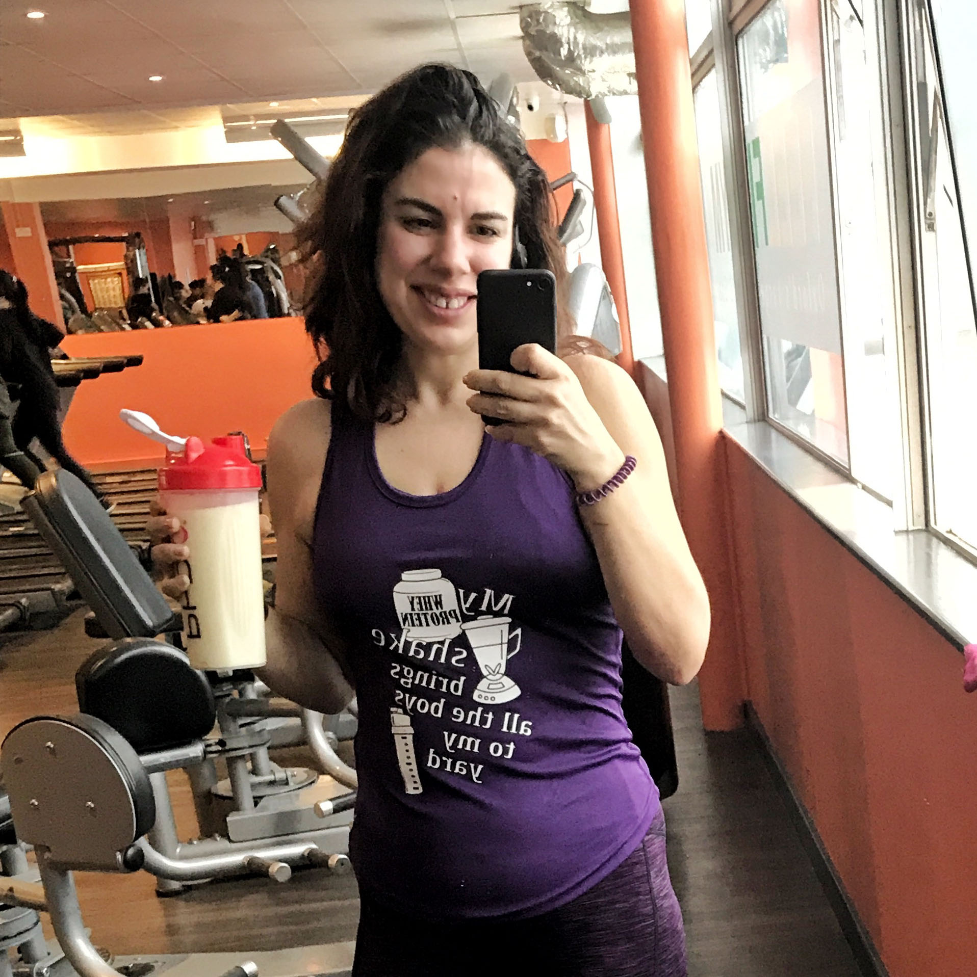 Rhiannon with a whey protein shake in self made gym vest